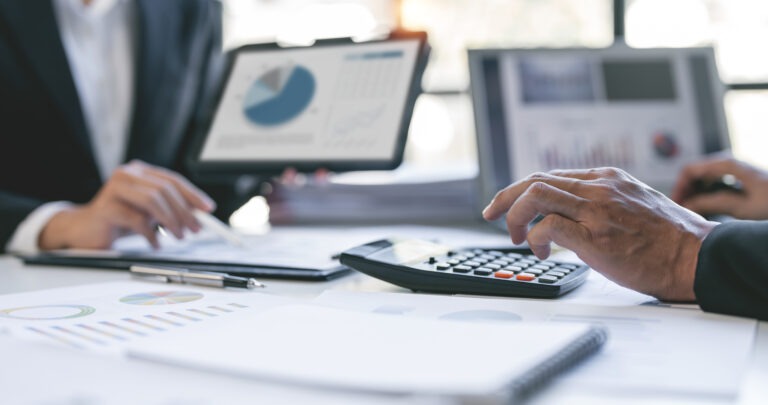 hands of people in suits working with financial data