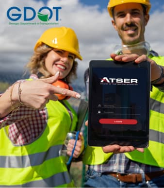Female and male construction workers showing iPad with ATSER dashboard